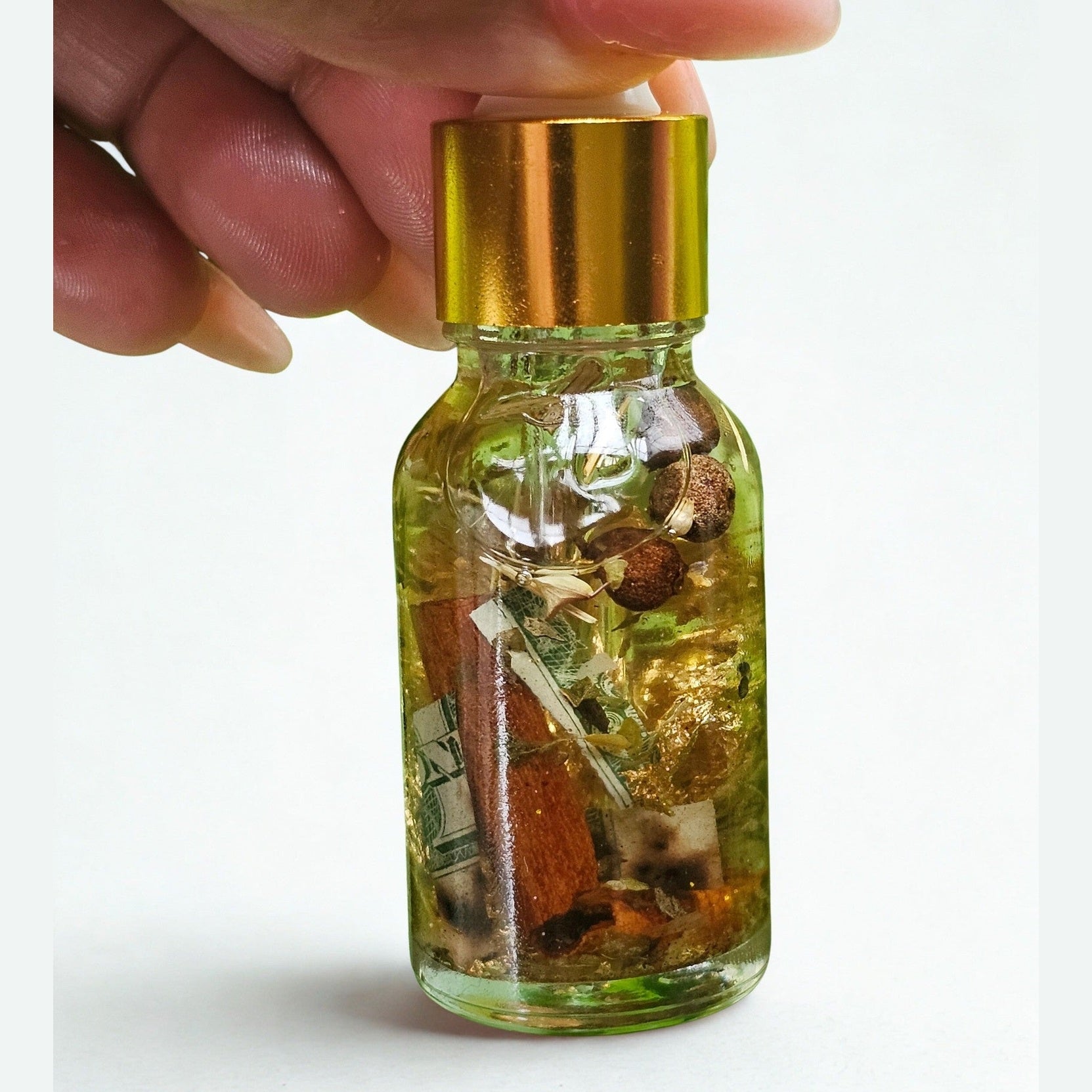 Rich Bitch Conjure Hoodoo Oil for money attraction, wealth, and prosperity rituals, displayed in a small glass bottle.
