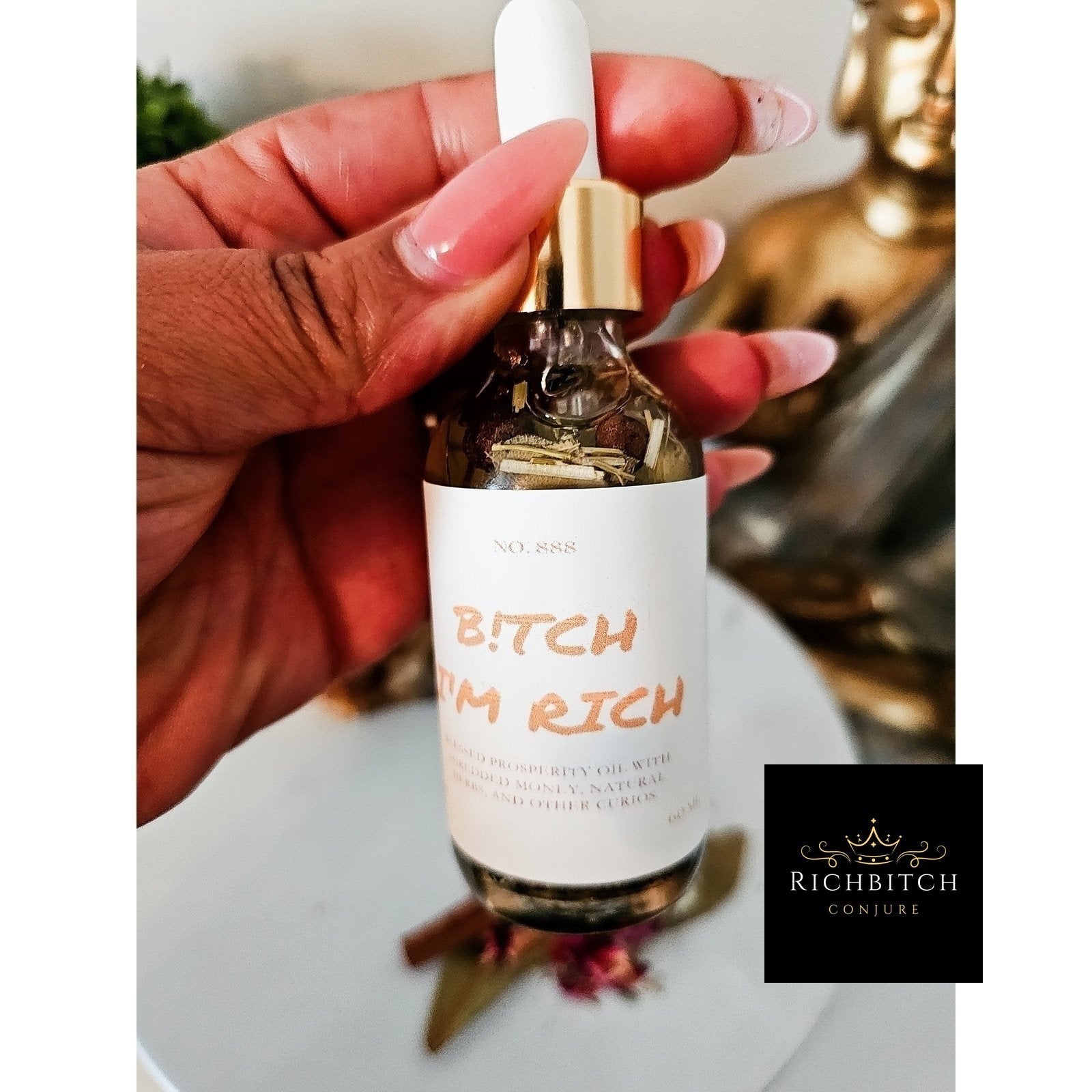 Rich Bitch Conjure Hoodoo Oil bottle labeled Rich Bitch Money Drawing Oil for wealth and prosperity rituals.