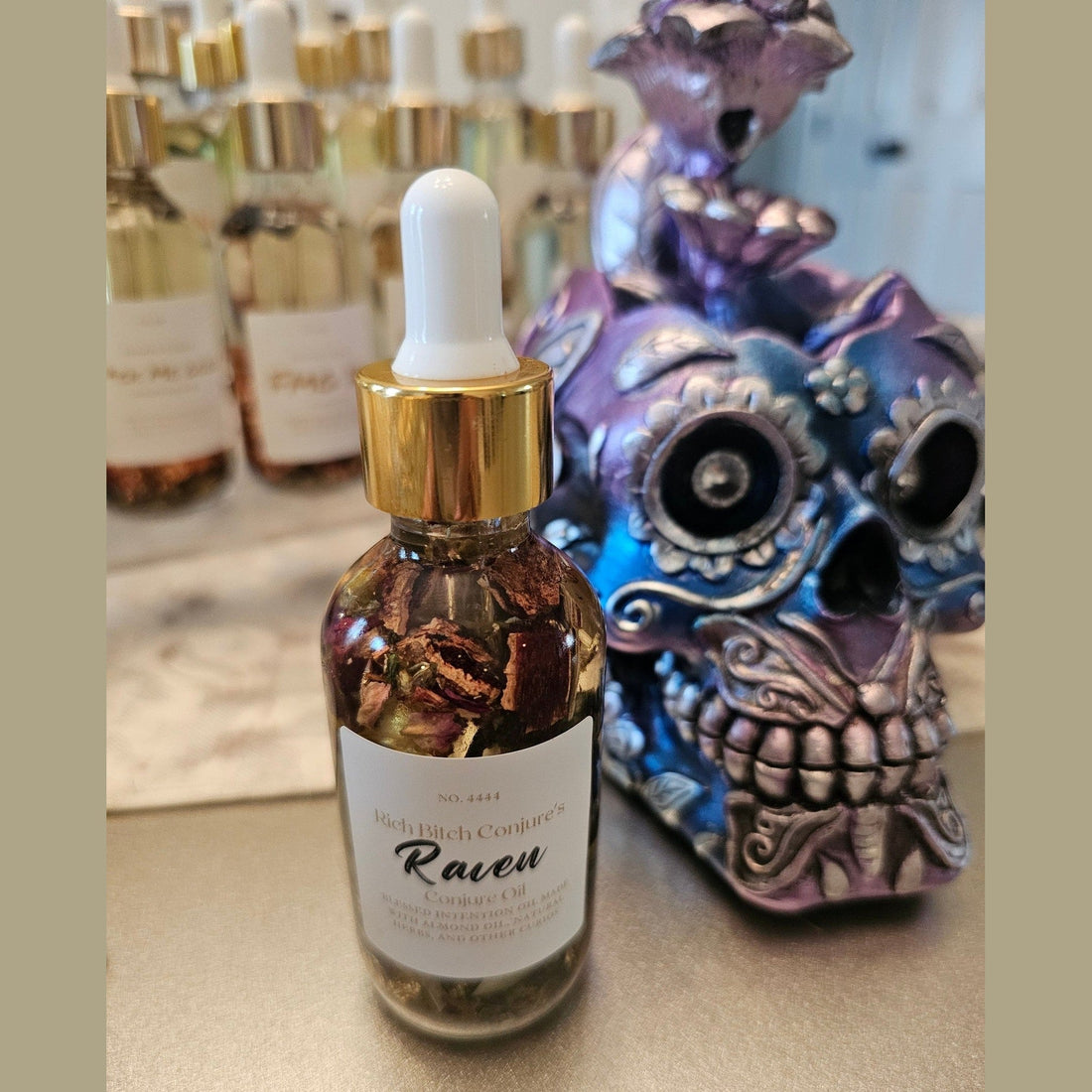 Rich Bitch Conjure Raven Hoodoo Oil in a small glass bottle, used for intuition, manifestation, and spiritual power rituals.