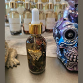 Rich Bitch Conjure Raven Hoodoo Oil in a small glass bottle for intuition, manifestation, and spiritual power rituals.