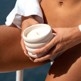 Salted Rivage soy wax ceramic candle by Italic, showing a white ceramic container with a lit wick and salted ocean-inspired design.