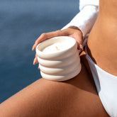 Soy wax ceramic candle by Italic with salted-rivage label, featuring a white ceramic holder and a softly glowing flame.