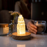 Selenite cleansing lamp night light by Conscious Items, glowing with a smooth, white selenite stone for calming ambient illumination.