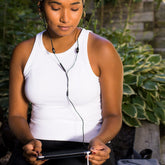 Shield Your Body SYB Tablet Pad supporting a woman outdoors, used as a stand for tablet computer in a natural setting.