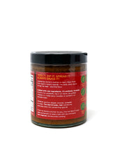Spicy red Mojo Picón sauce in a jar with a spoon, featuring vibrant red color and the label "The Red Drizzler, HOT" by Simrancooks