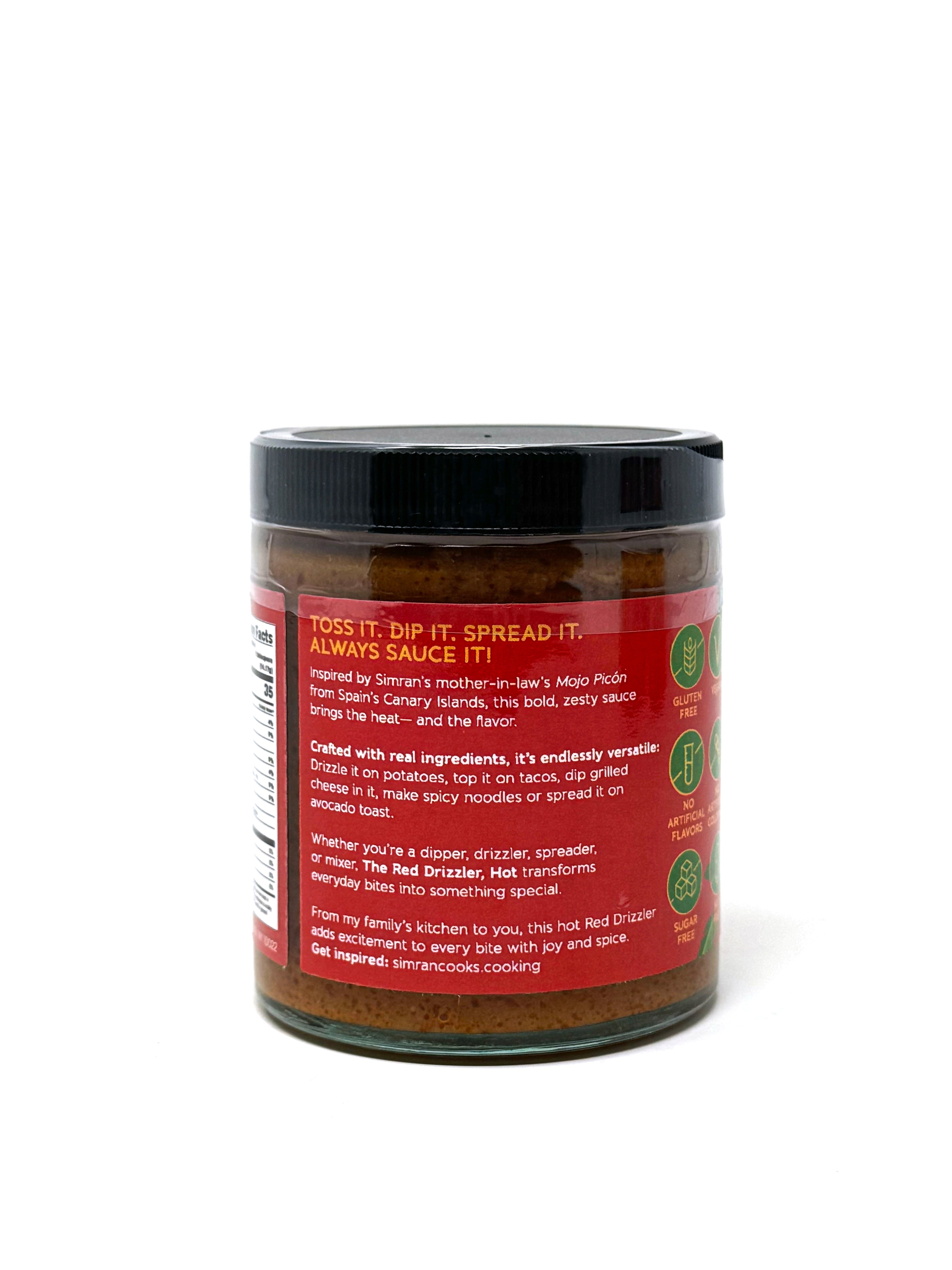 Spicy red Mojo Picón sauce in a jar with a spoon, featuring vibrant red color and the label "The Red Drizzler, HOT" by Simrancooks