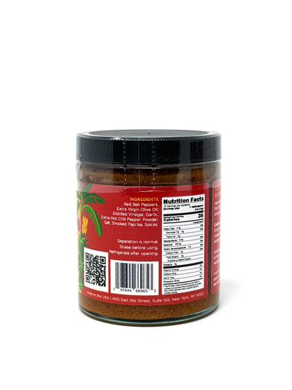 Red Mojo Picon sauce from Simrancooks in a glass jar, showcasing its vibrant red color and hot, spicy ingredients.