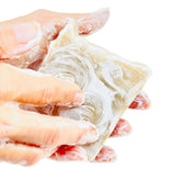 Handmade soap bar with pure tallow, honey, goat milk, and soap suds, showcasing a natural, fragrance-free skincare product.