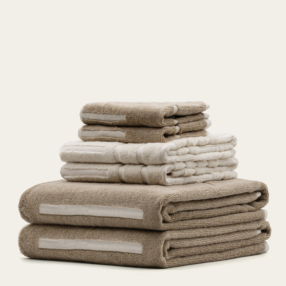 Set of Sorrel Australian Cotton Towels by Italic, soft and plush, displayed folded on a wooden surface.