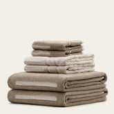Set of Sorrel Australian Cotton Towels by Italic, soft and plush, displayed folded on a wooden surface.