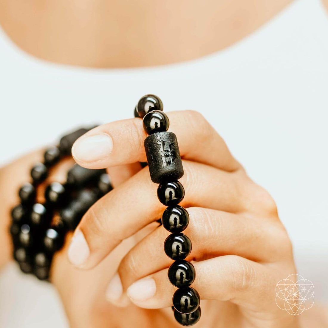 Black Obsidian bracelet by Conscious Items featuring polished, smooth black stones for soul cleansing and spiritual protection.