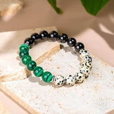 Dalmatian Jasper healing bracelet by Conscious Items featuring black and white spotted stones on a stretch cord.