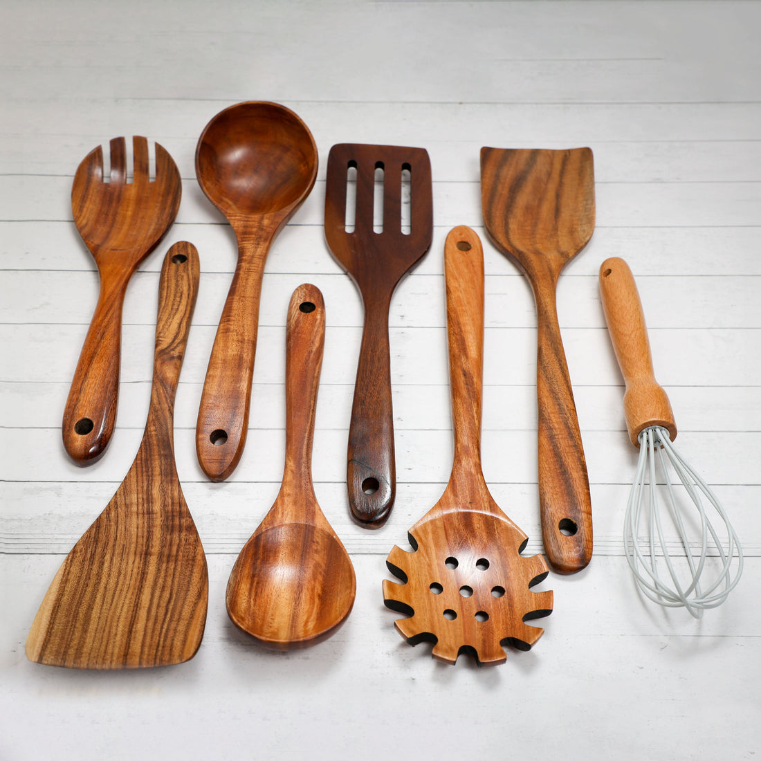 Set of acacia wooden spoons from Spice Wheel arranged in containers, showcasing natural wood grain and craftsmanship.