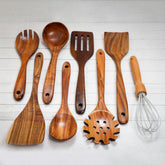 Set of acacia wooden spoons from Spice Wheel arranged in containers, showcasing natural wood grain and craftsmanship.