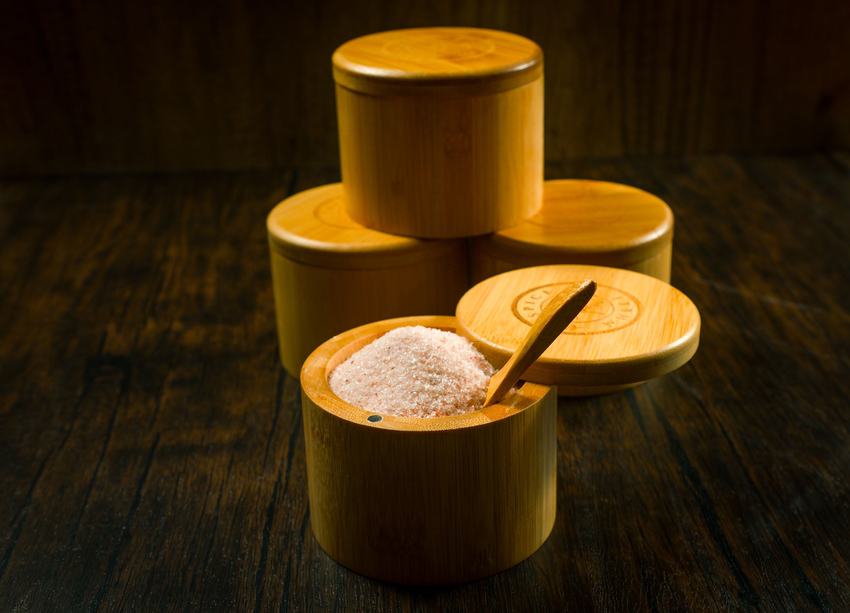 Bamboo salt container filled with pink Himalayan salt, Spice Wheel container for kitchen storage and spice organization.