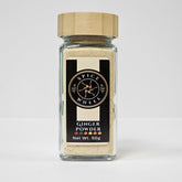Fine ginger powder from Spice Wheel, showcasing a close-up of the aromatic, freshly ground ginger spice in a glass jar.