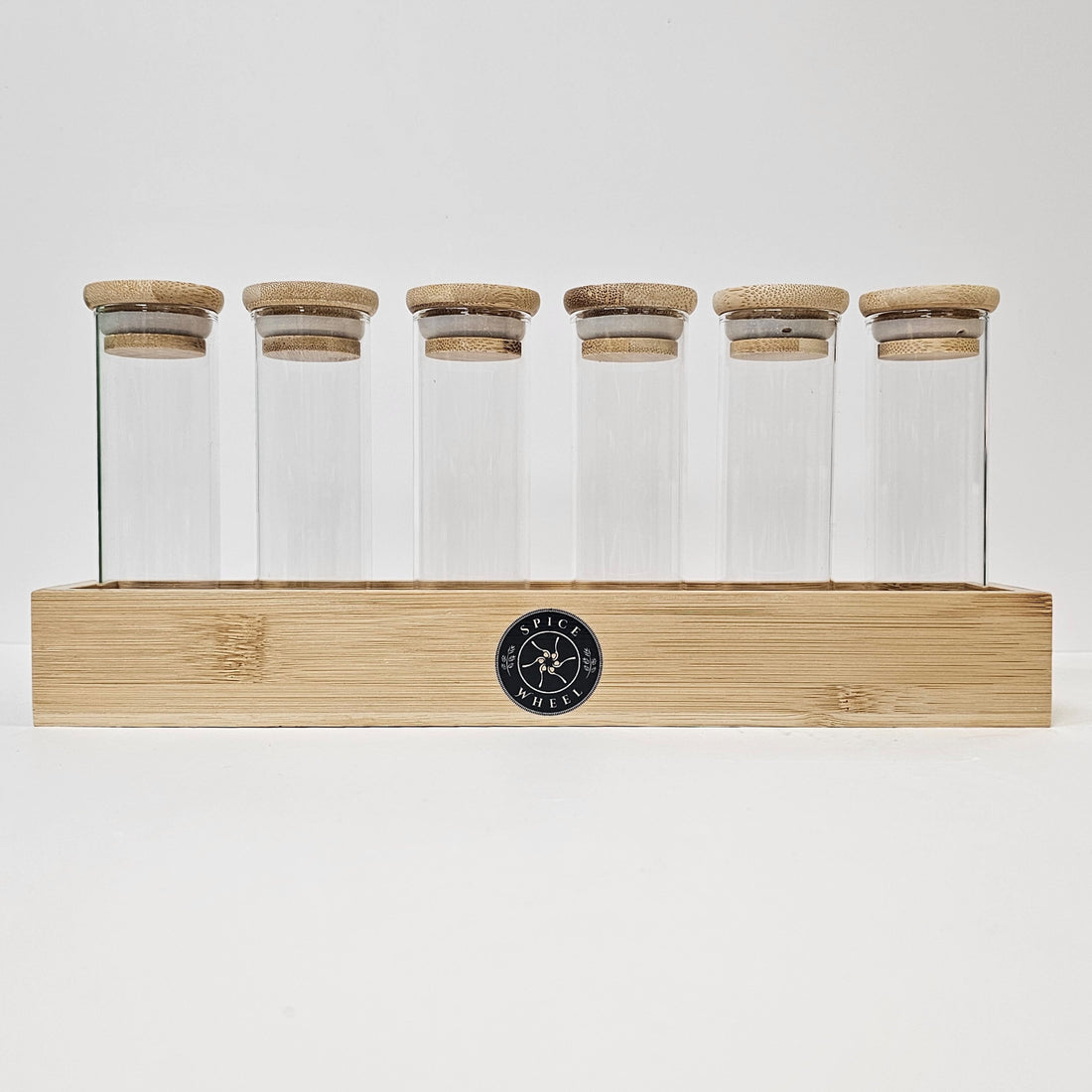 Clear glass storage tubes from Spice Wheel collection, ideal for organizing spices or small items in a sleek, transparent design.