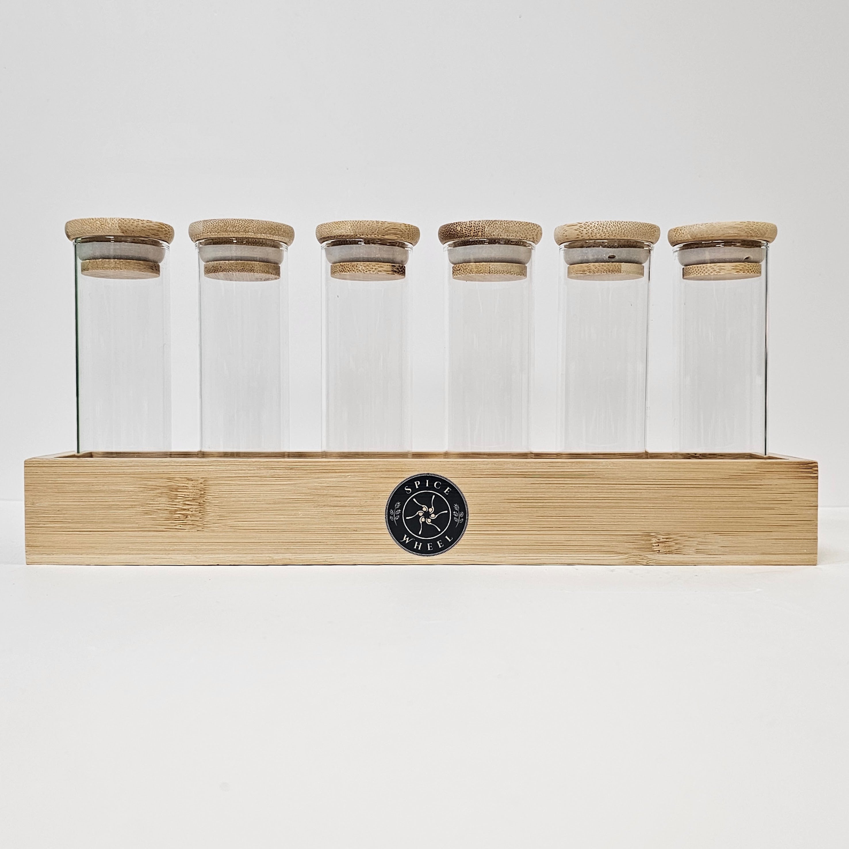 Clear glass storage tubes from Spice Wheel collection, ideal for organizing spices or small items in a sleek, transparent design.