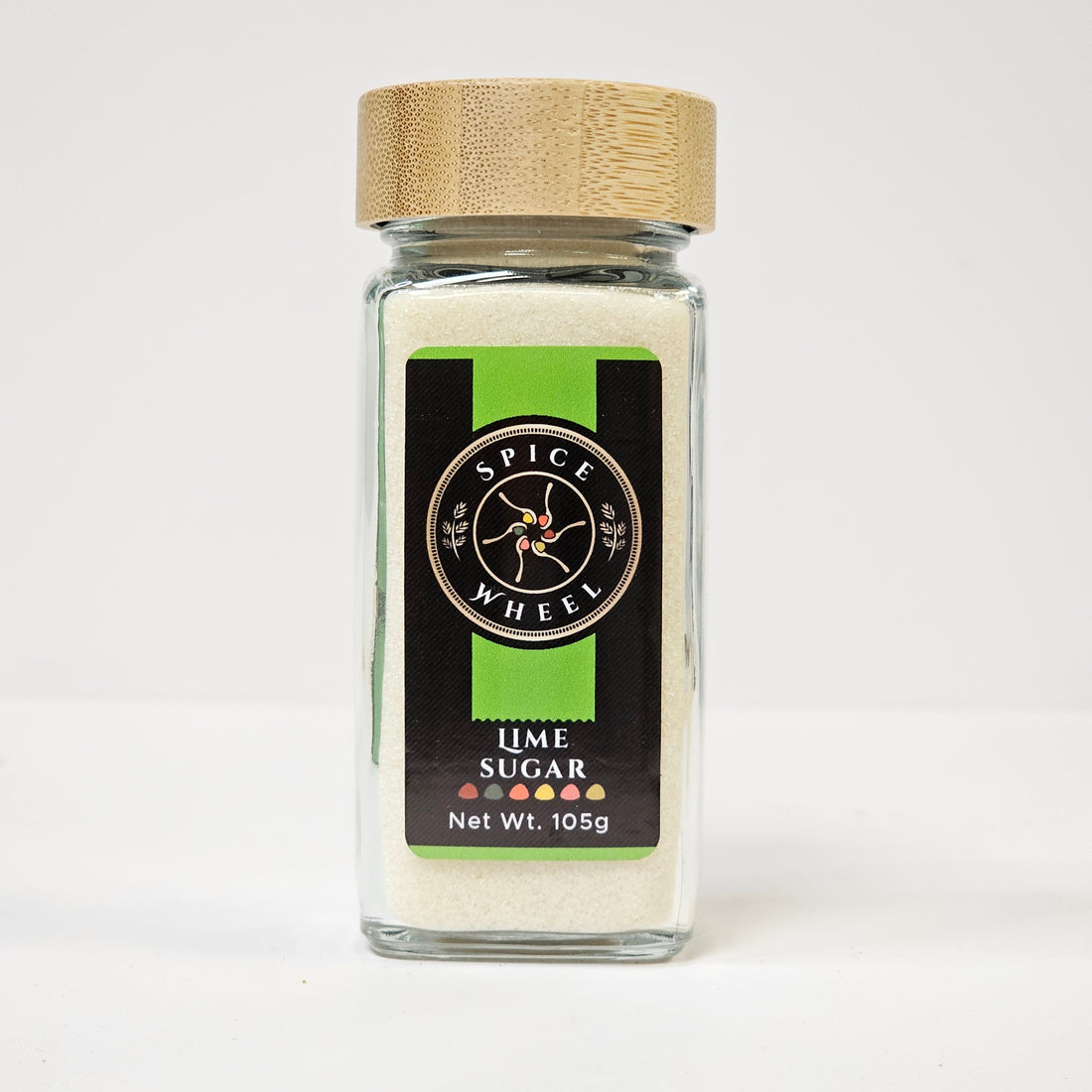 Bright lime sugar from Spice Wheel, showing a jar of vibrant green lime-flavored sugar crystals on a wooden surface.