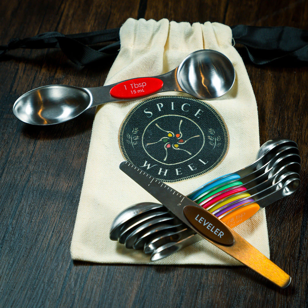 Set of Spice Wheel magnetic spoons with built-in leveler in a canvas gift bag for easy storage and organization.