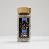 Glass jar of Blueberry Sugar from Spice Wheel, filled with vibrant blue-colored blueberry-flavored sugar for baking and cooking.