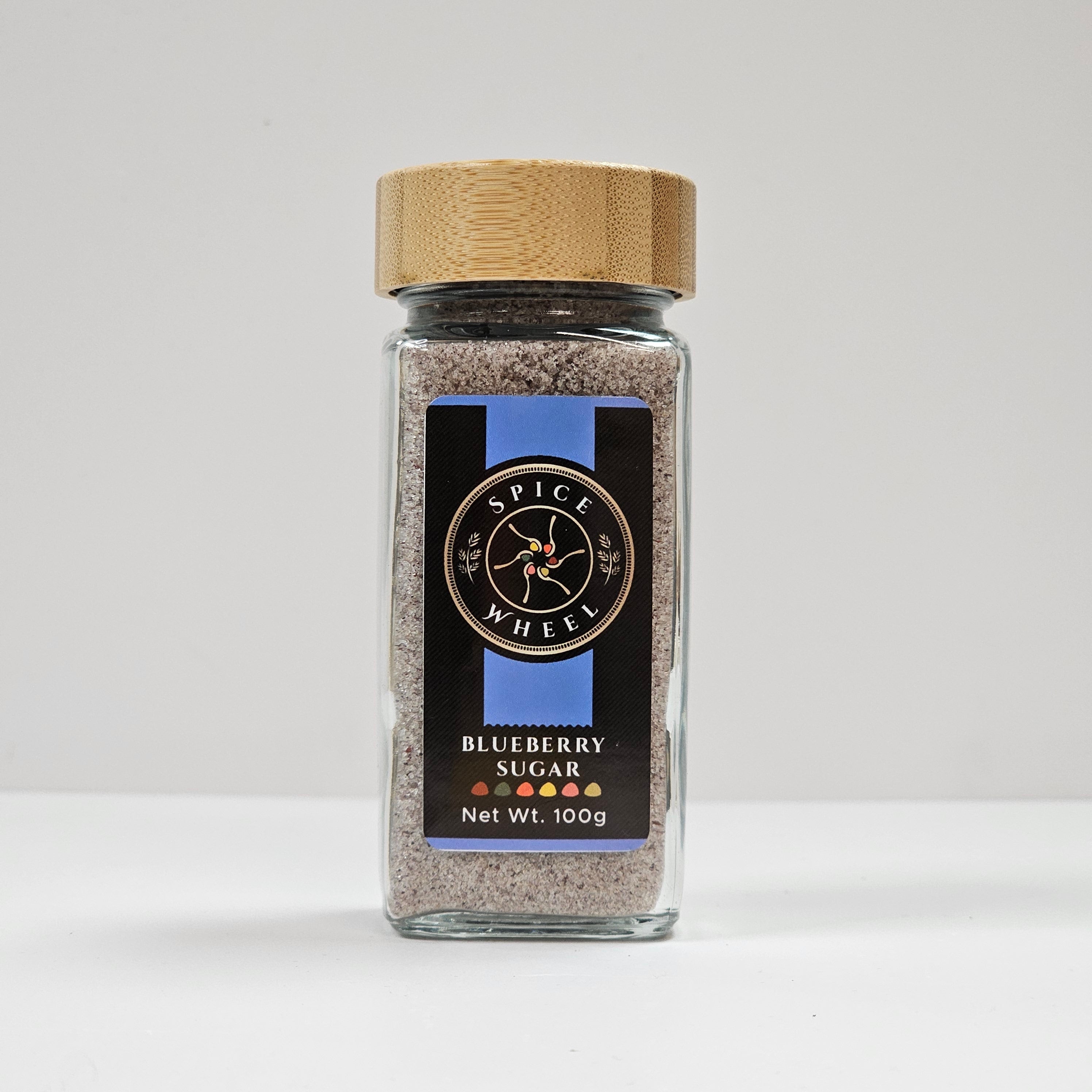 Glass jar of Blueberry Sugar from Spice Wheel, filled with vibrant blue-colored blueberry-flavored sugar for baking and cooking.