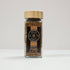 Glass jar of Spice Wheel Brown Za’atar with a label, containing a blend of herbs and spices for culinary use.