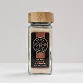 Glass jar of caramel sugar from Spice Wheel, showcasing the smooth caramel-colored sugar inside.