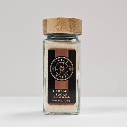Glass jar of caramel sugar from Spice Wheel, showcasing the smooth caramel-colored sugar inside.