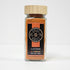 Glass jar of cayenne pepper by Spice Wheel, showing vibrant red cayenne peppers inside the clear glass container.