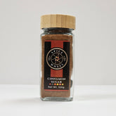 Glass jar of Spice Wheel cinnamon sugar with a clear view of the label and cinnamon sugar inside.