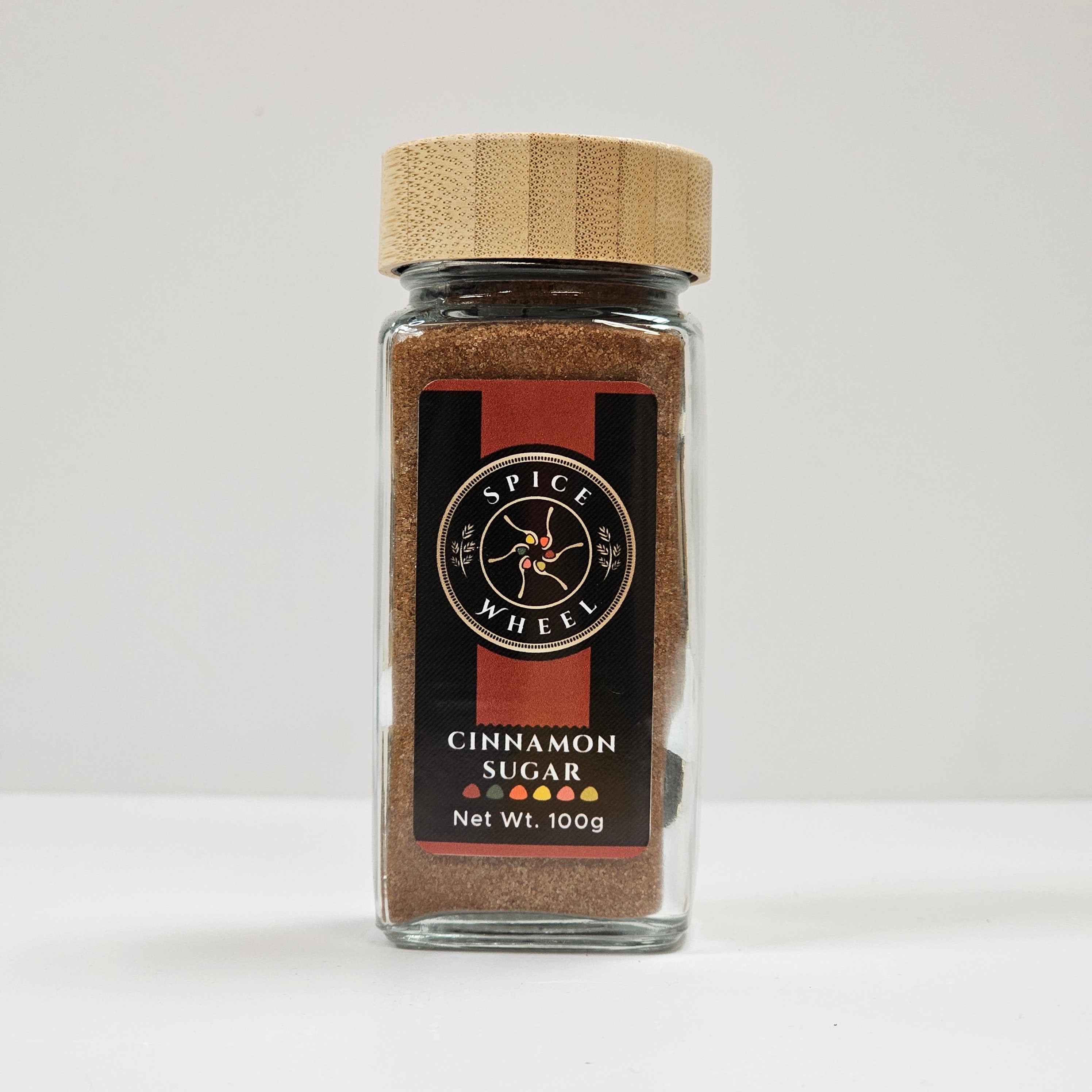 Glass jar of Spice Wheel cinnamon sugar with a clear view of the label and cinnamon sugar inside.