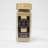 Glass jar of Spice Wheel coriander powder, showing the finely ground green herb inside the clear container.