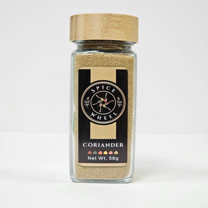 Glass jar of Spice Wheel coriander powder, showing the finely ground green herb inside the clear container.