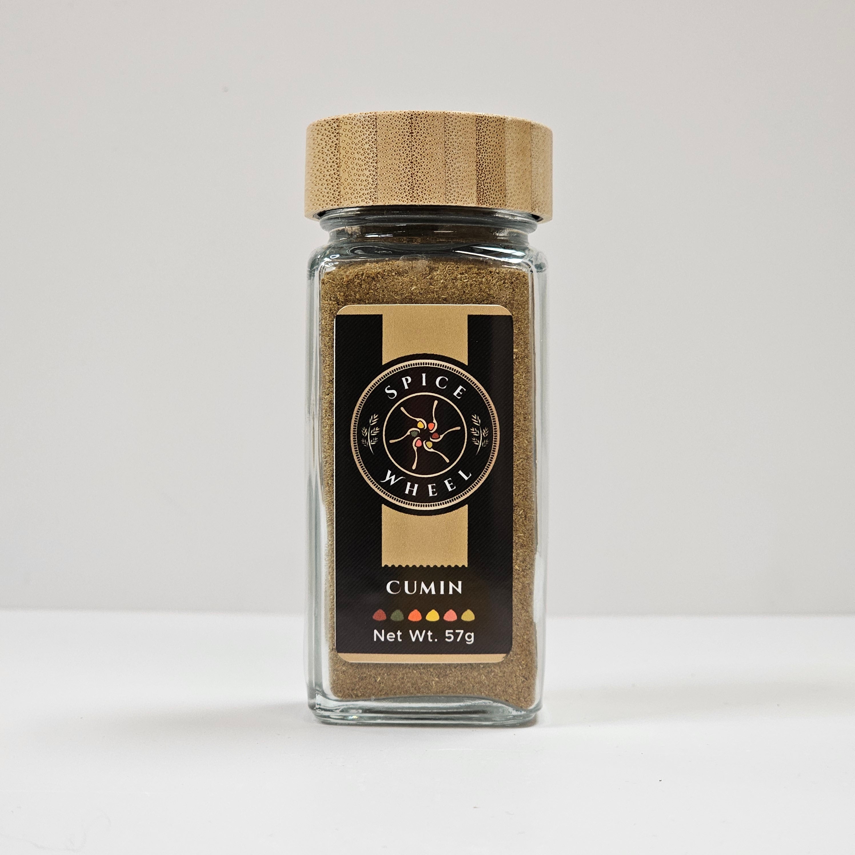 Glass jar of Spice Wheel cumin powder with a clear view of the finely ground spice inside.