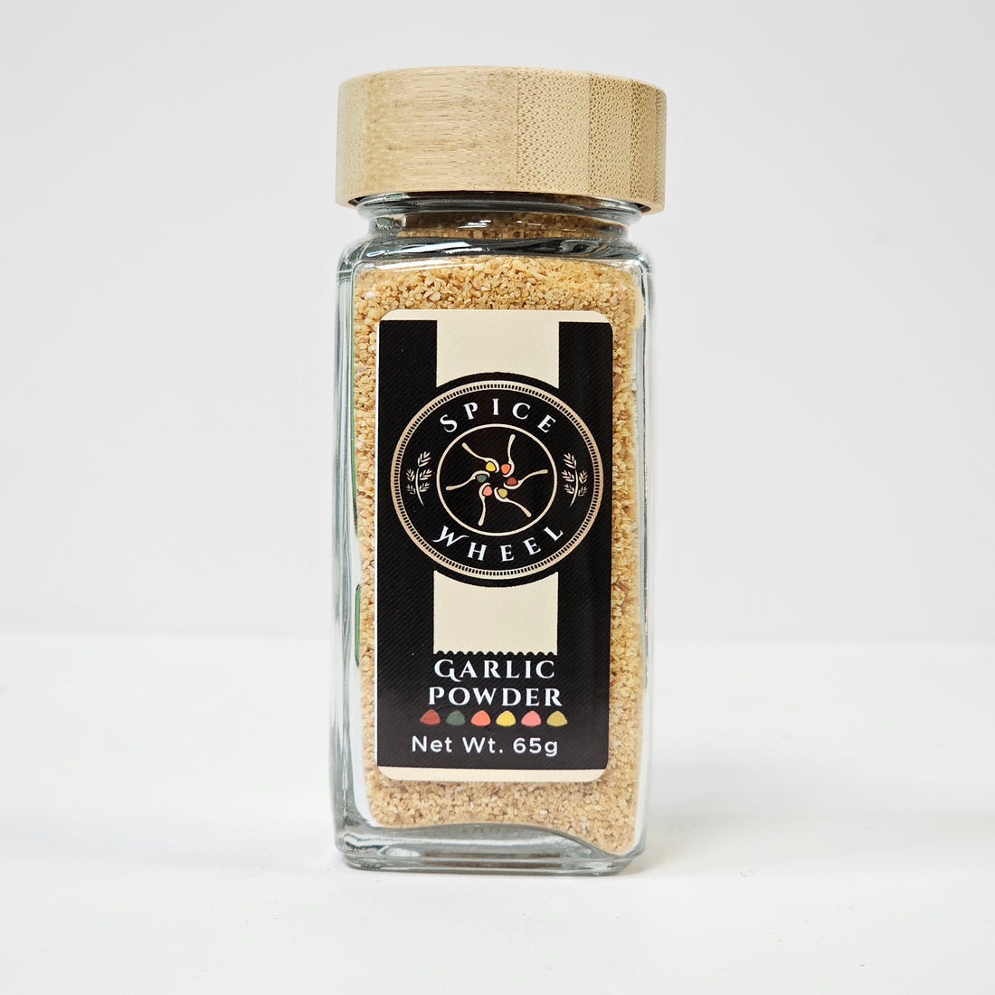 Glass jar of Spice Wheel garlic powder, showing the white garlic powder inside with a clear view of the jar and lid.