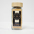 Glass jar of Spice Wheel garlic powder, showing the white garlic powder inside with a clear view of the jar and lid.