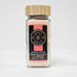 Himalayan pink sea salt in a clear glass jar, showcasing the coarse pink crystals, from Spice Wheel.