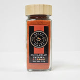 Glass jar of Hungarian paprika spice from Spice Wheel, showing vibrant red powder inside a clear container.