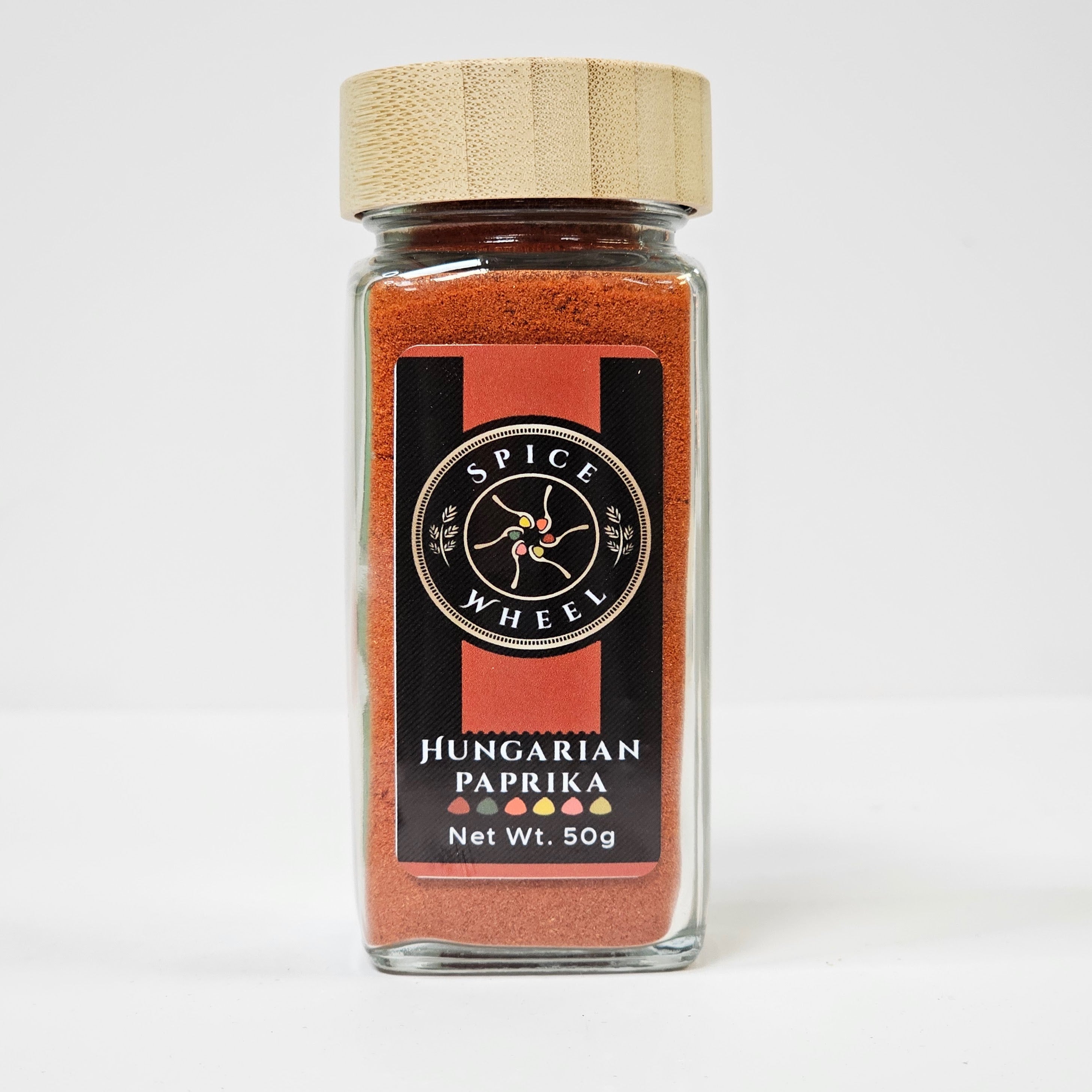 Glass jar of Hungarian paprika spice from Spice Wheel, showing vibrant red powder inside a clear container.