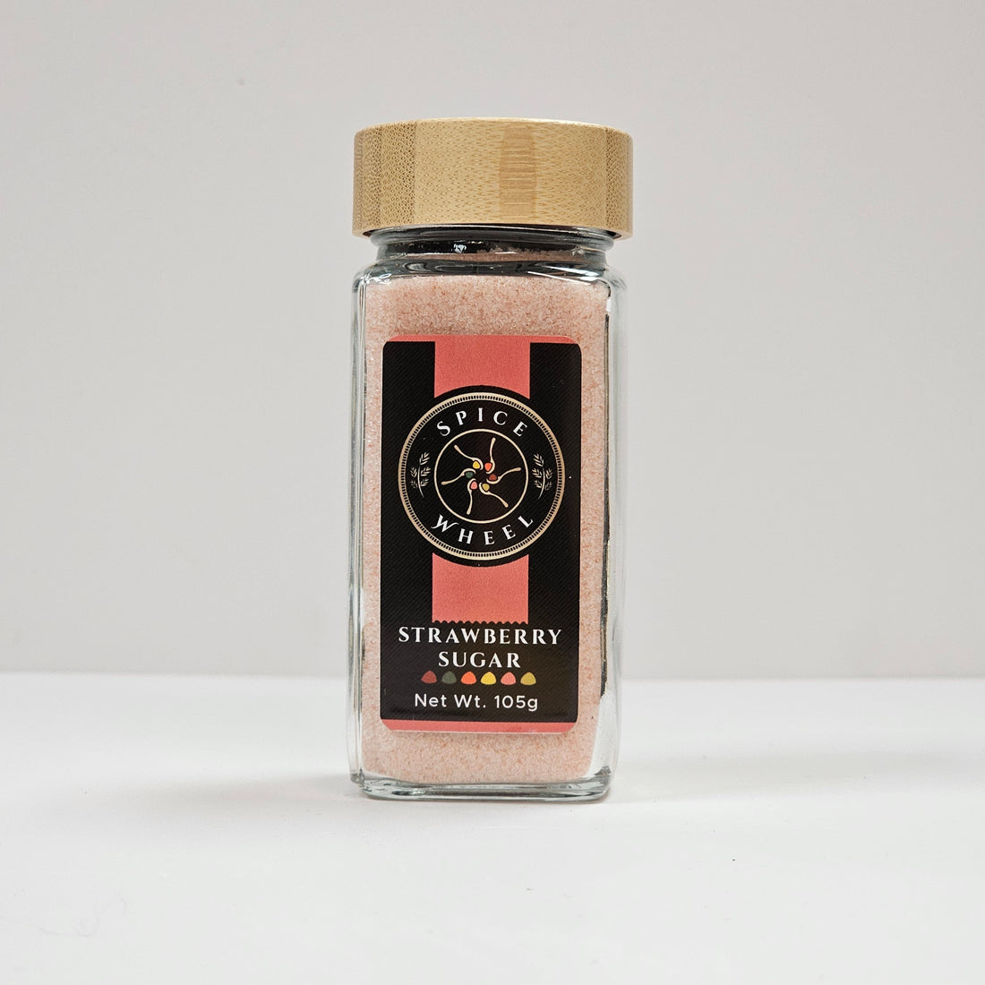 Glass jar of strawberry sugar from Spice Wheel, showcasing the vibrant, sweet strawberry sugar inside the clear container.