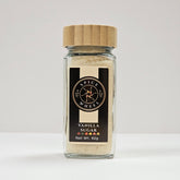 Glass jar of vanilla sugar by Spice Wheel, showing the clear container filled with white vanilla sugar crystals.