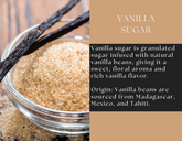 Glass jar of vanilla sugar from Spice Wheel, with a clear label and white sugar inside, on a neutral background.