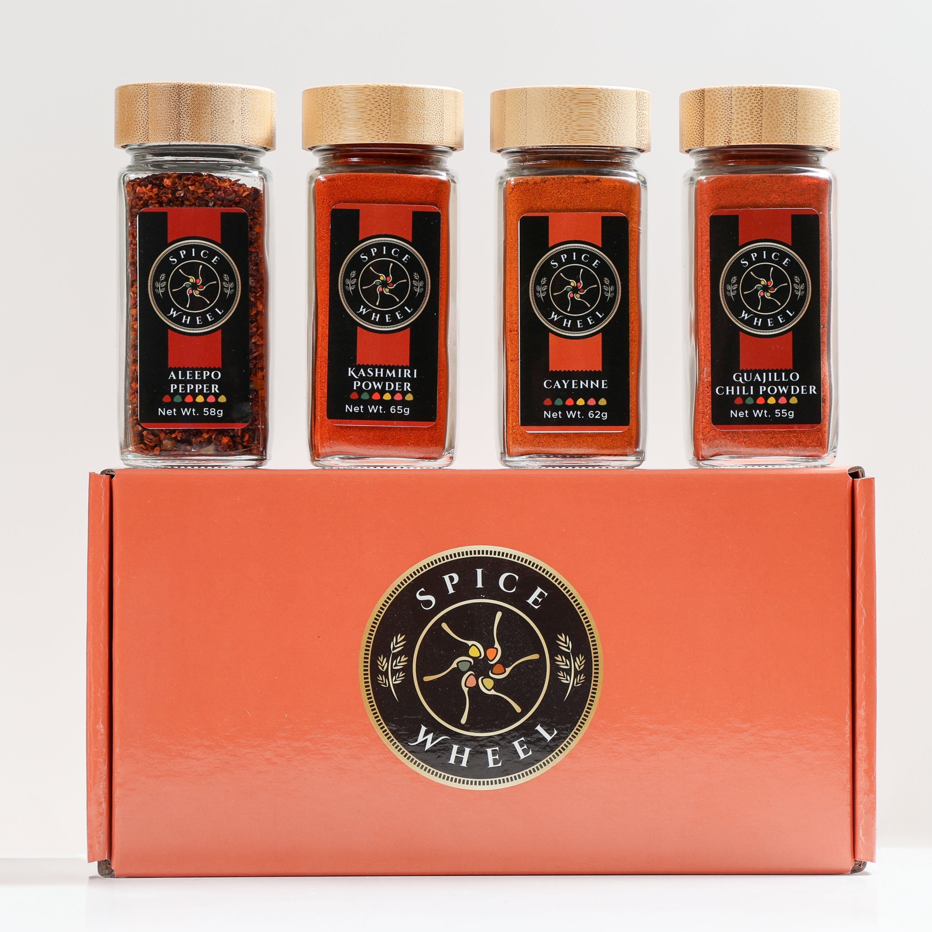 Spice Wheel Fiery Four Gift Set featuring four global hot spices in colorful jars, perfect for heat lovers.