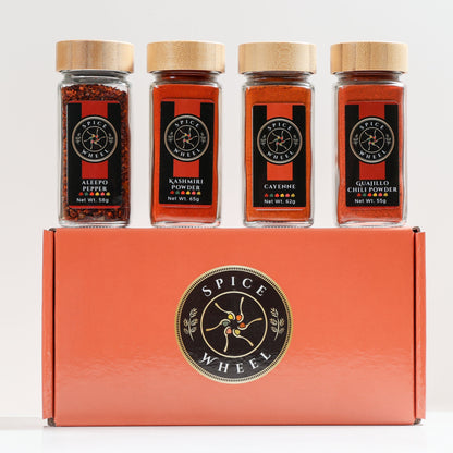 Spice Wheel Fiery Four Gift Set featuring four global hot spices in colorful jars, perfect for heat lovers.