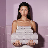 Set of Capri Australian Cotton Towels by Italic, soft and plush home bath towels displayed on a model.