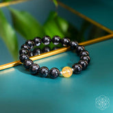 Deep healing bracelet featuring Arfvedsonite gemstone, designed by Conscious Items with natural stone beads on an elastic band.