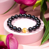 Deep healing bracelet featuring Arfvedsonite gemstone with natural black and gray tones, designed by Conscious Items.