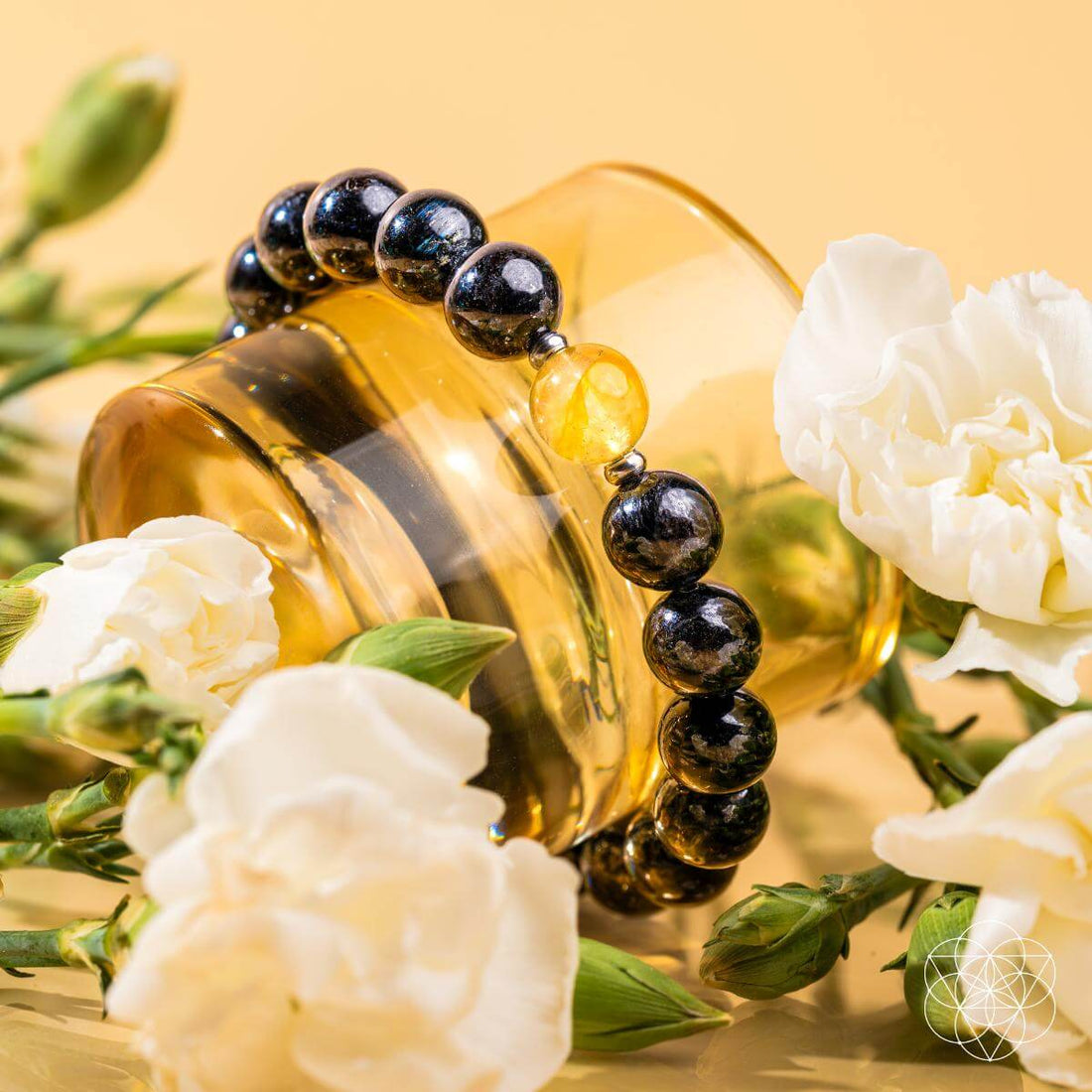 Deep healing bracelet with Arfvedsonite gemstone by Conscious Items, featuring dark, polished stones on a flexible cord.