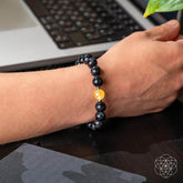 Deep healing bracelet featuring Arfvedsonite crystal, crafted by Conscious Items, showcasing a sleek, polished stone bracelet design.